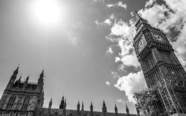 Black and white photo of Big Ben and the Palace of Westminster in London, with the sun shining brightly—a striking backdrop perfect for a corporate event or seminar in this iconic city.