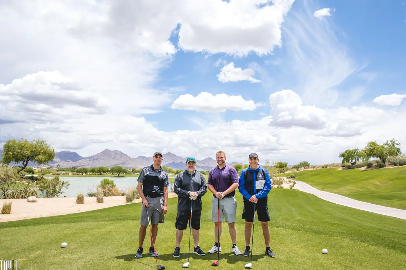 Four men posing on a golf course at an Arizona resort