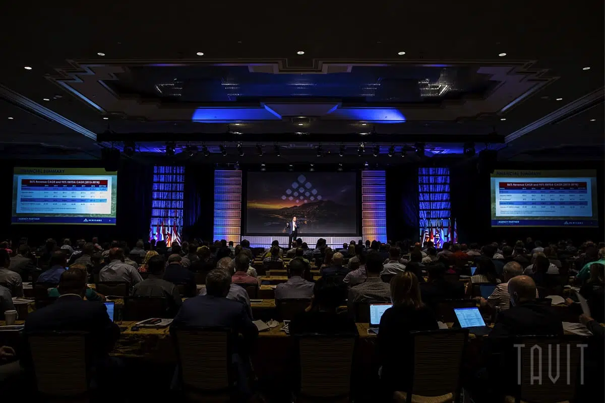 Man speaking on stage at corporate event