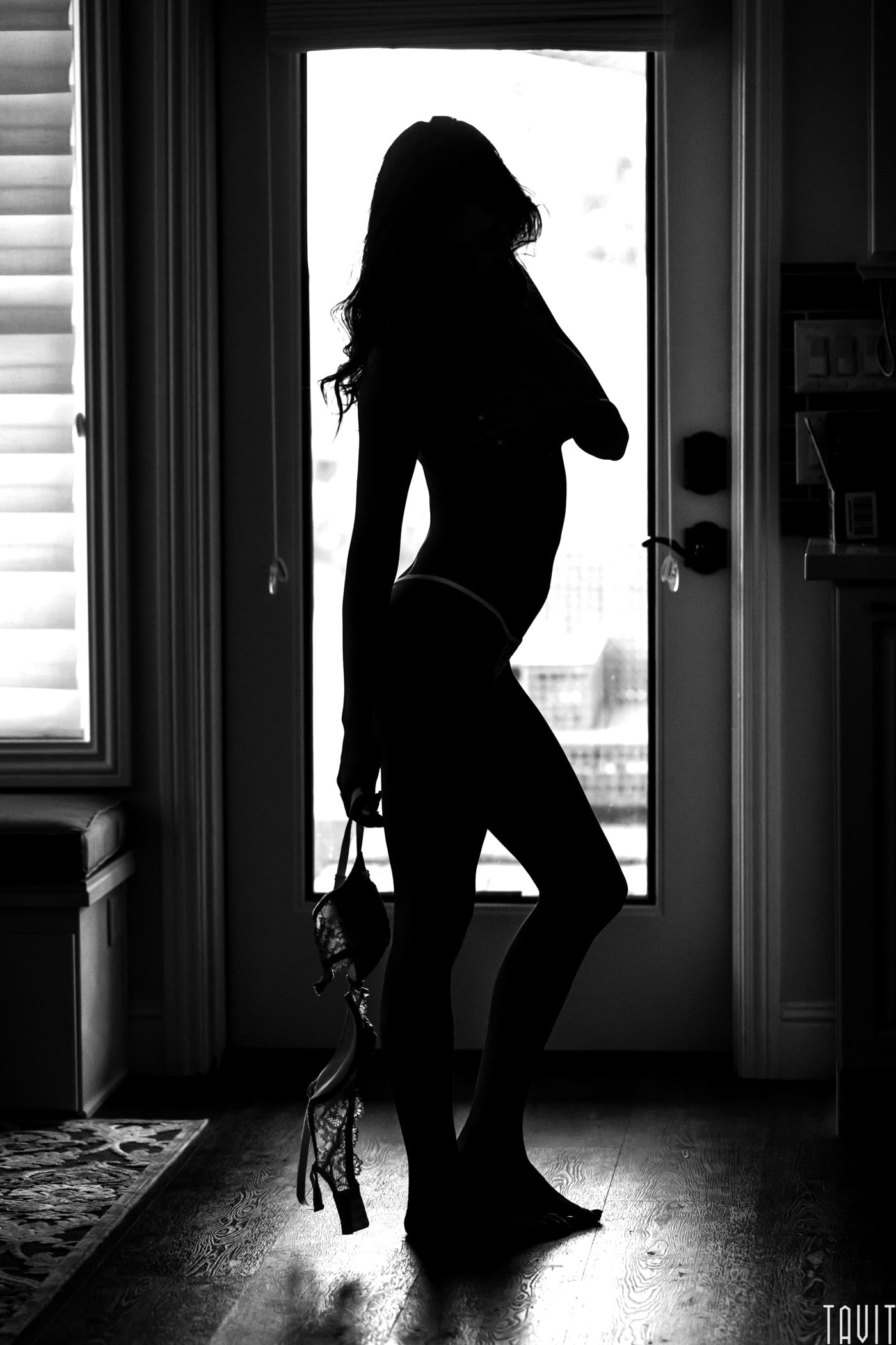 Boudoir model silhouette holding bra