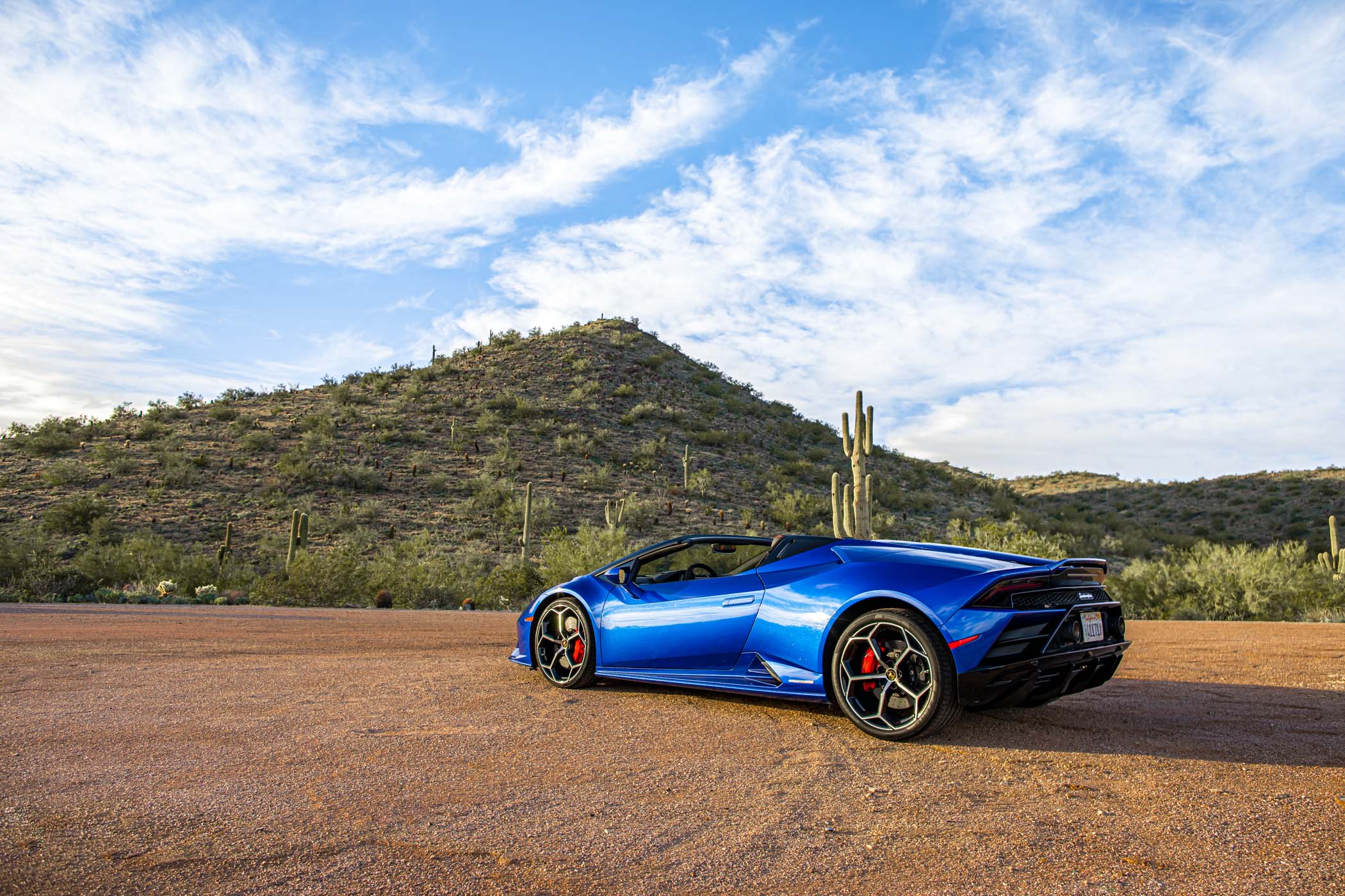 Lamborghini side view with desert mountain