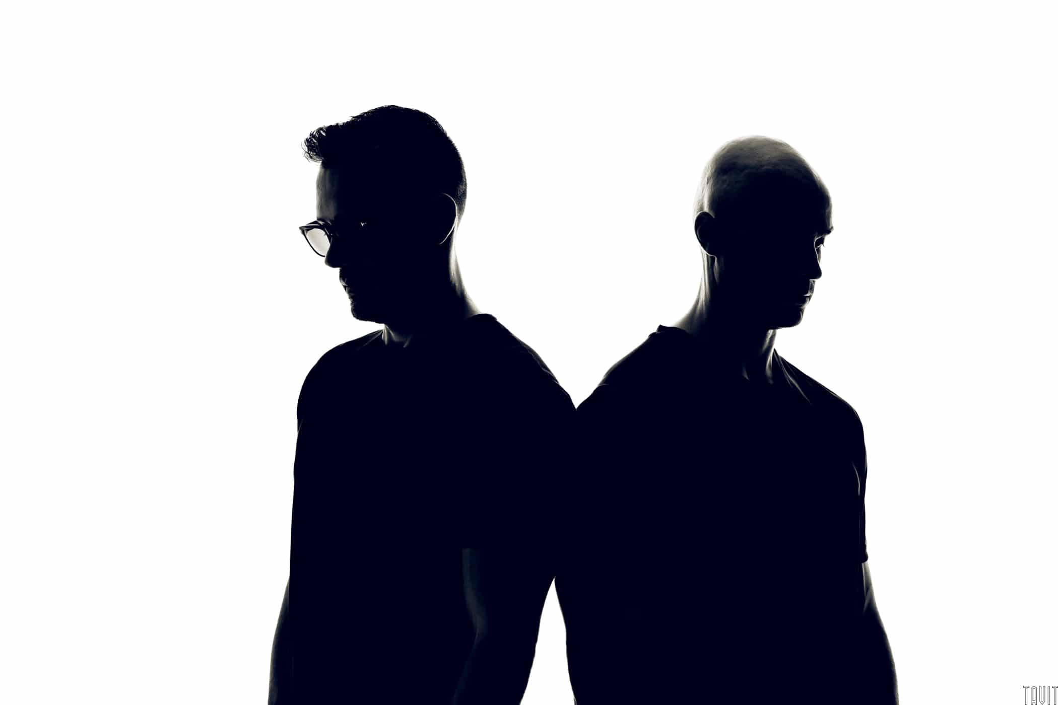 Two men looking down silhouette headshot