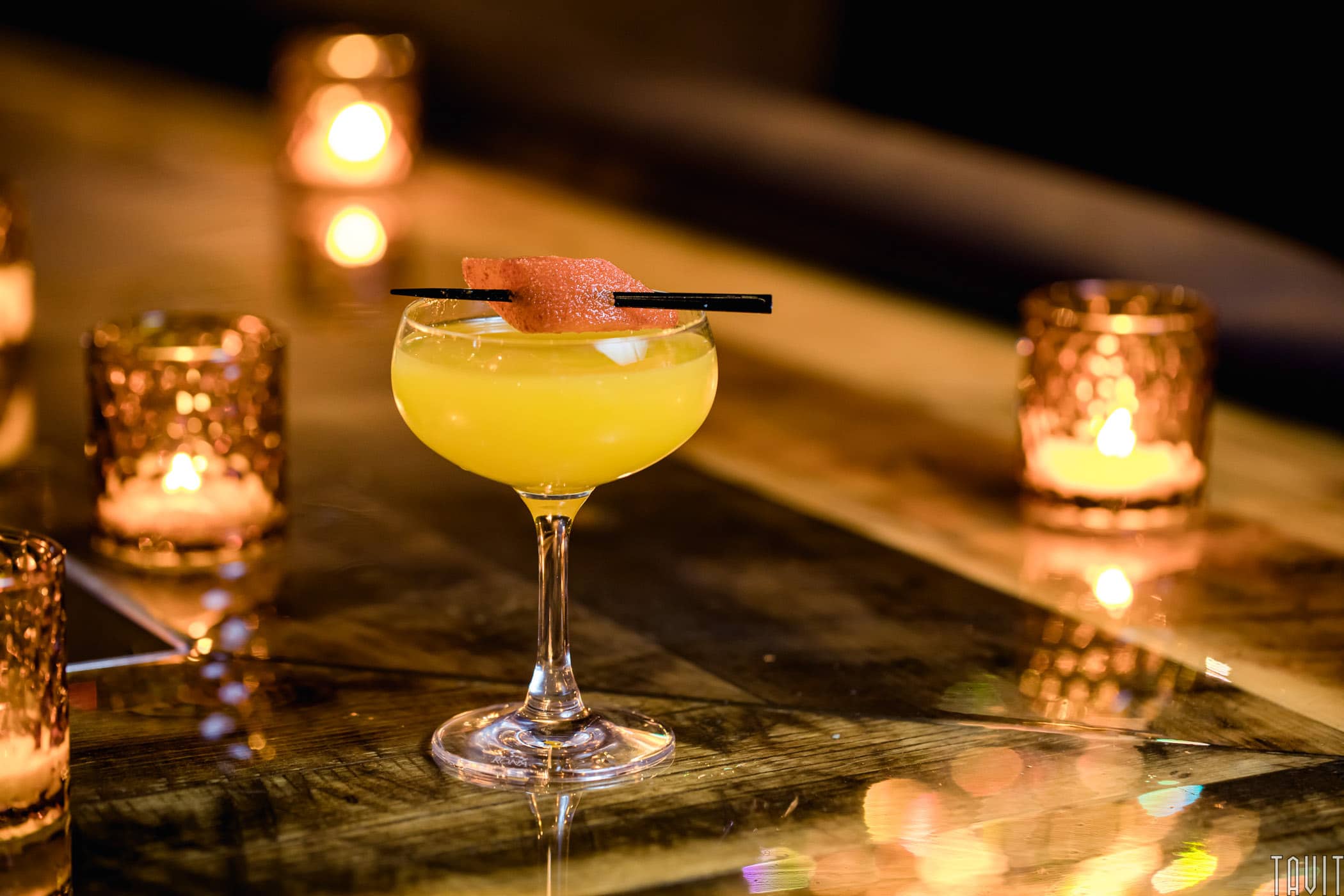 Orange cocktail with candles
