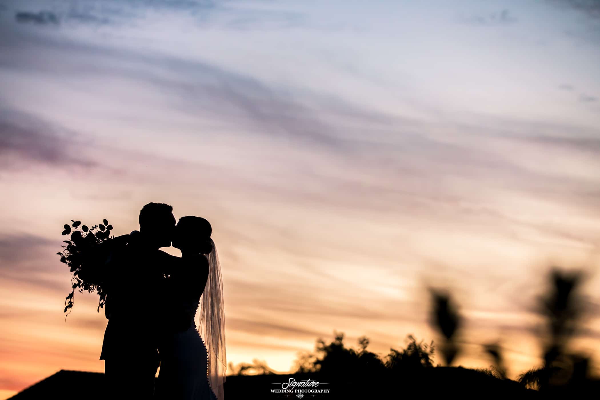 Bride and groom sunset silhouette