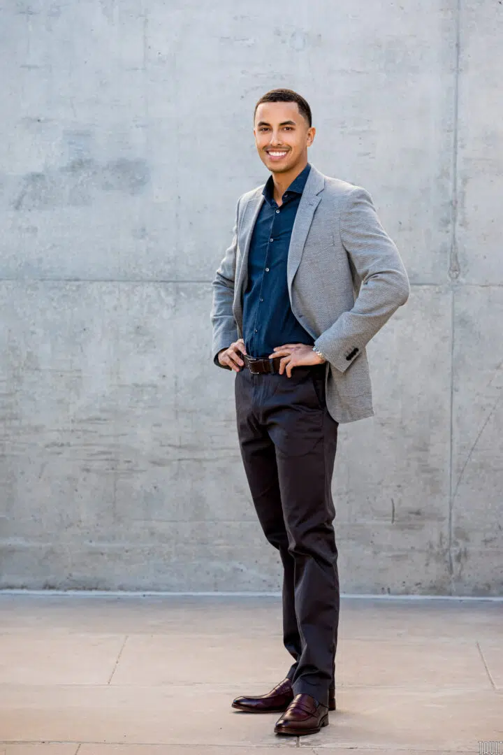 Professional headshot of a man standing outside