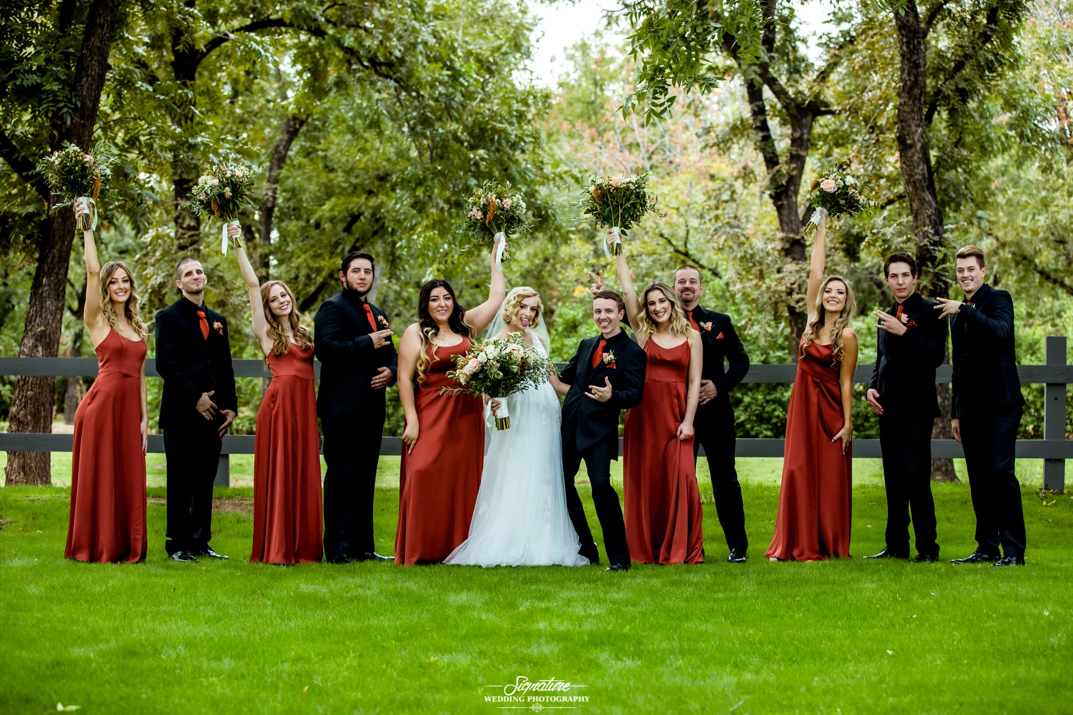 Fun pose of wedding party outside