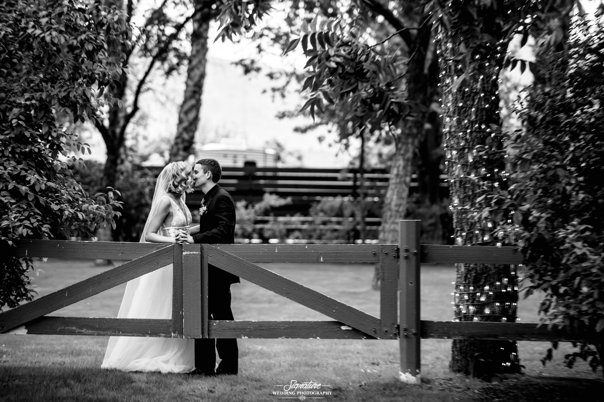 Couple kissing outside black and white wedding photo