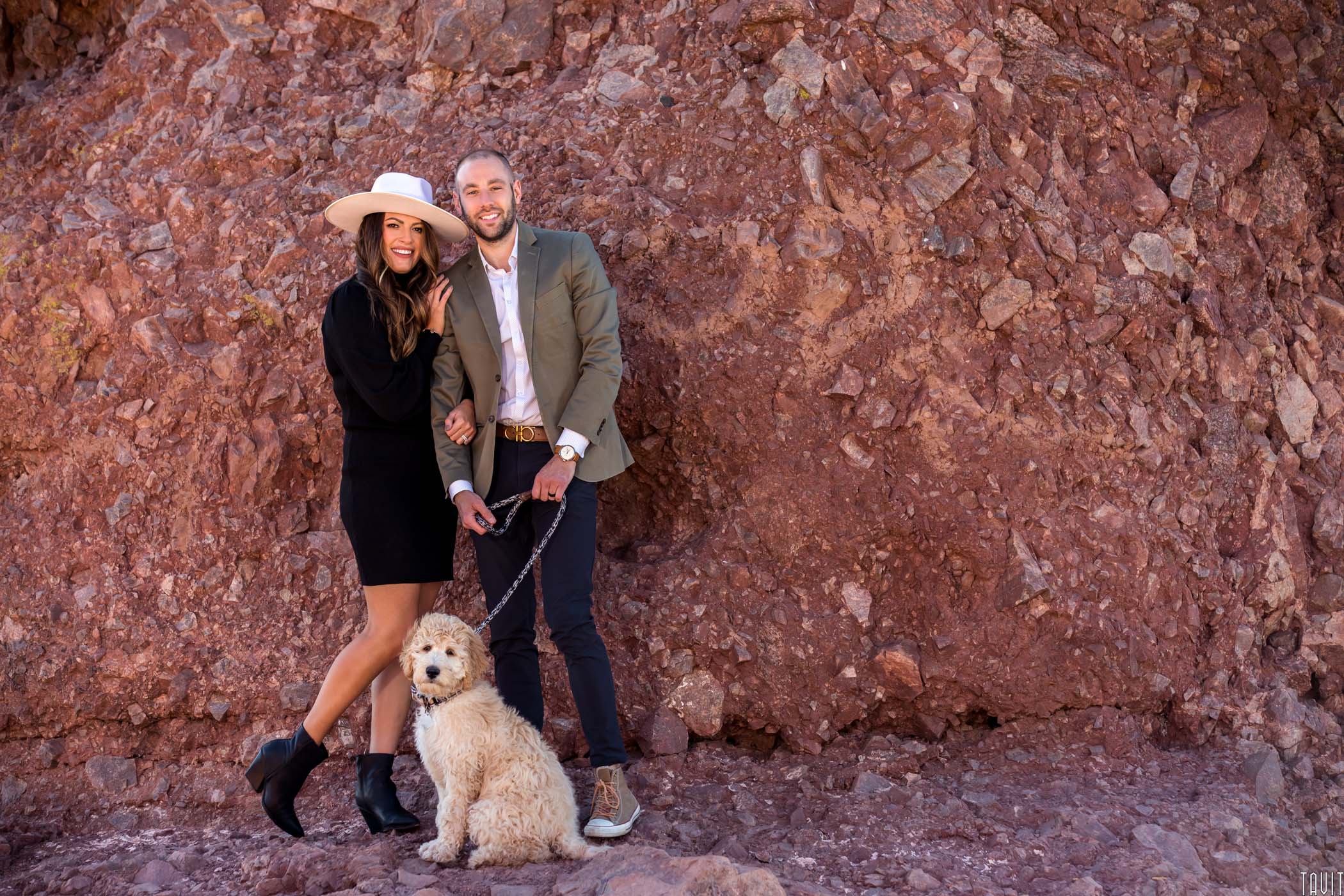 Husband, Wife and dog in front of a mountain