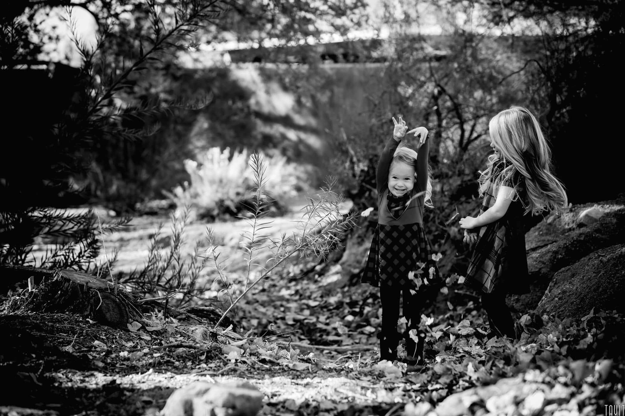 B&W of two sisters playing outdoors