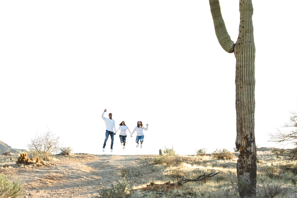 Family jumping in desert