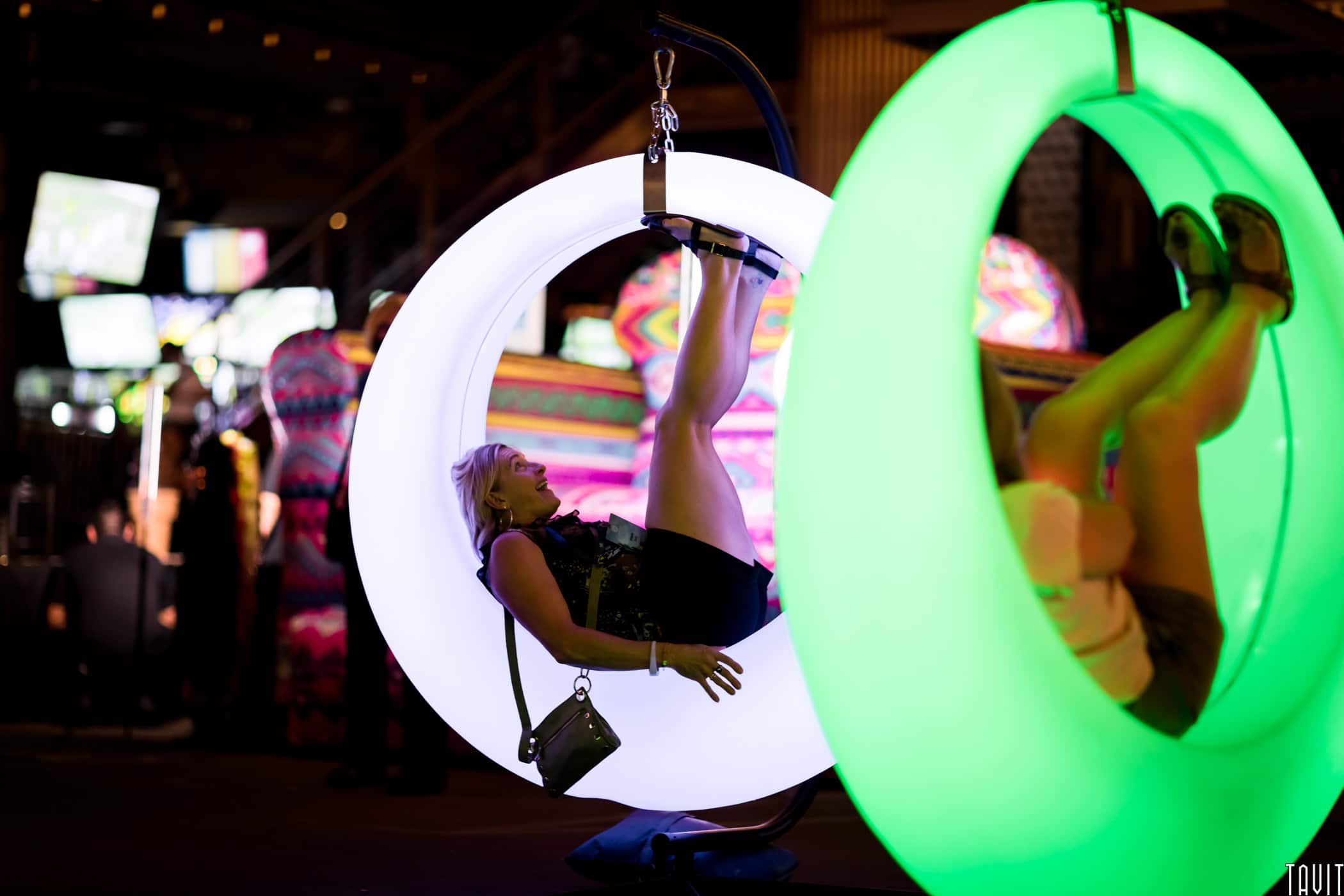 People sitting in light up hoop chairs