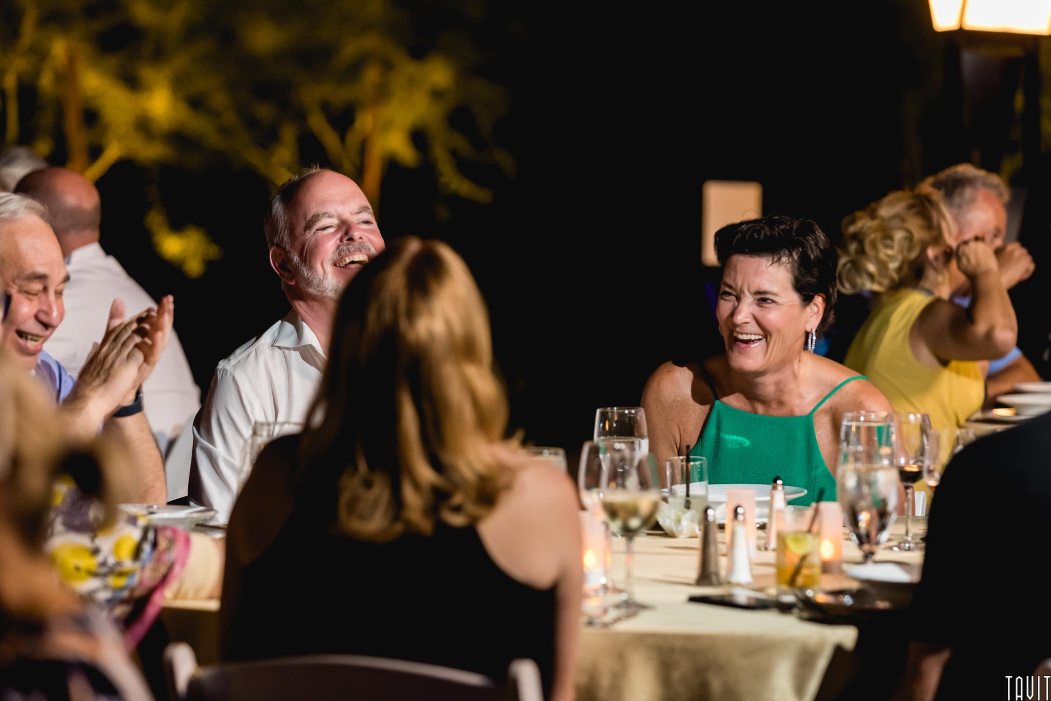 People laughing at table for outside event