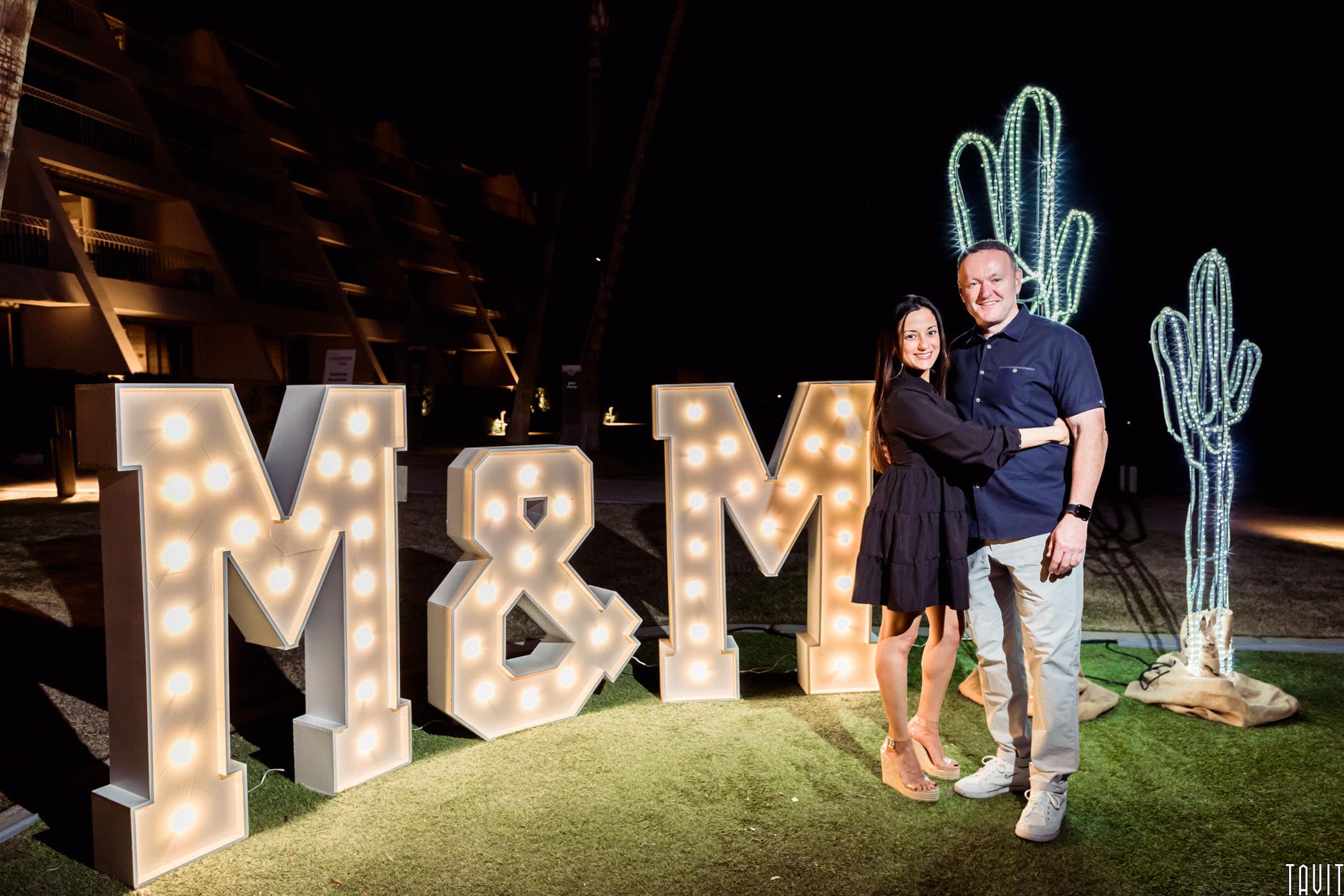 Couple in front of M&M light up sign