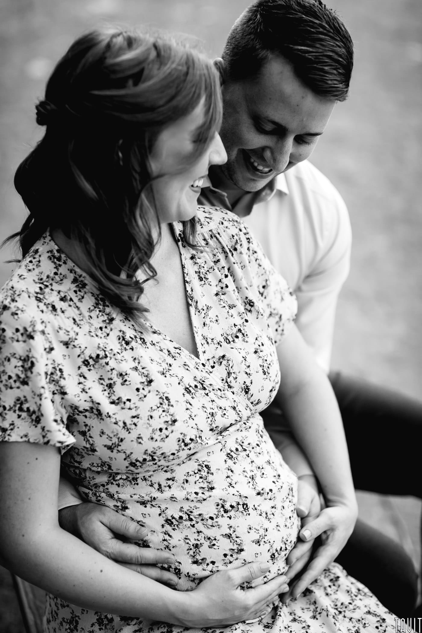 Couple holding woman's tummy for maternity shoot black and white