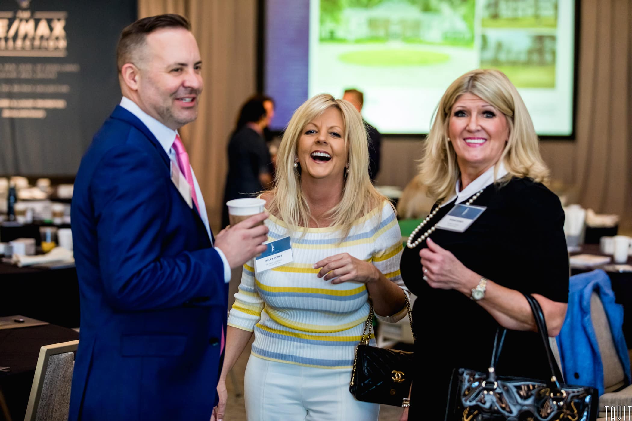 People laughing at business event