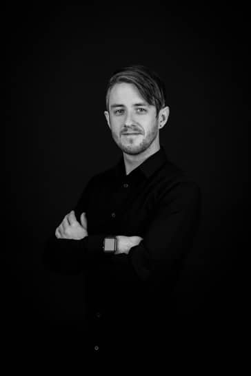 Jacob with arms crossed business headshot black and white