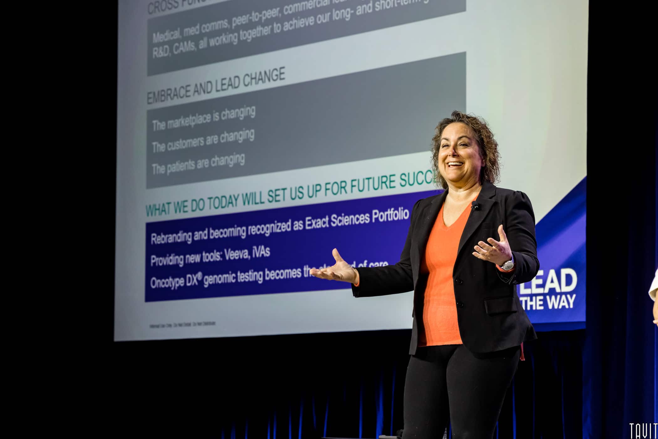 Woman giving presentation on stage for business event