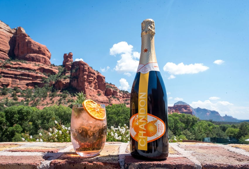 Chandon Champagne bottle and glass in front of desert mountain