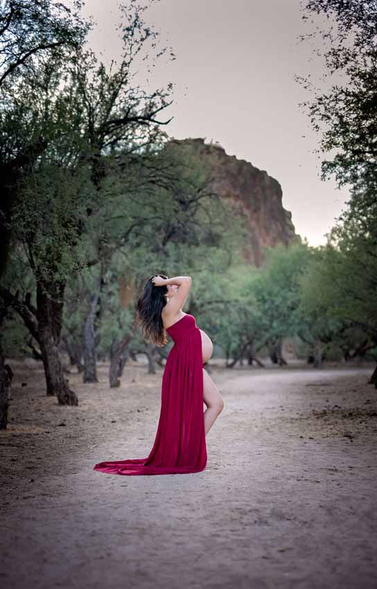 Woman in red dress in desert maternity shoot