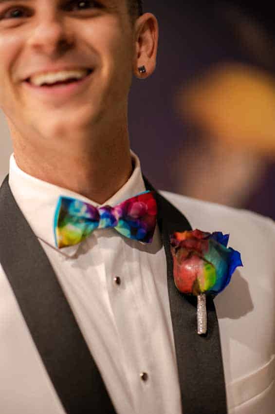 Groom with rainbow bowtie and rose