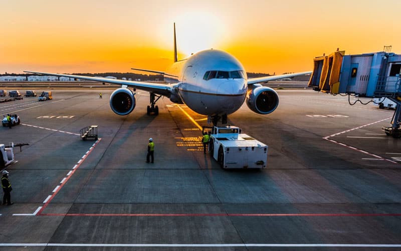 Airplane on tarmac at sunset