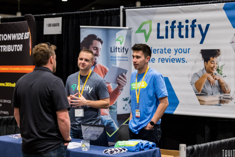 People looking at display booth during business event