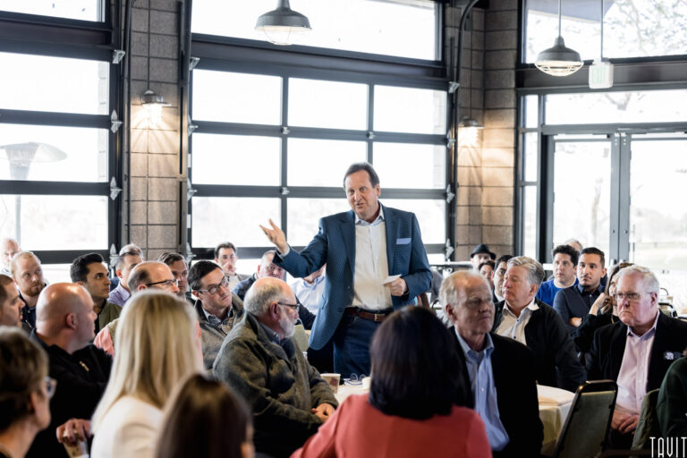 Man giving speech in the middle of audience