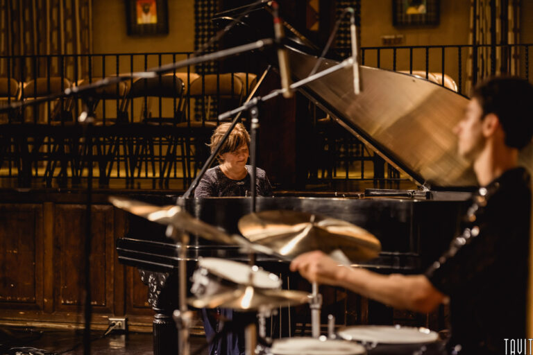 Side stage view of drummer and pianist