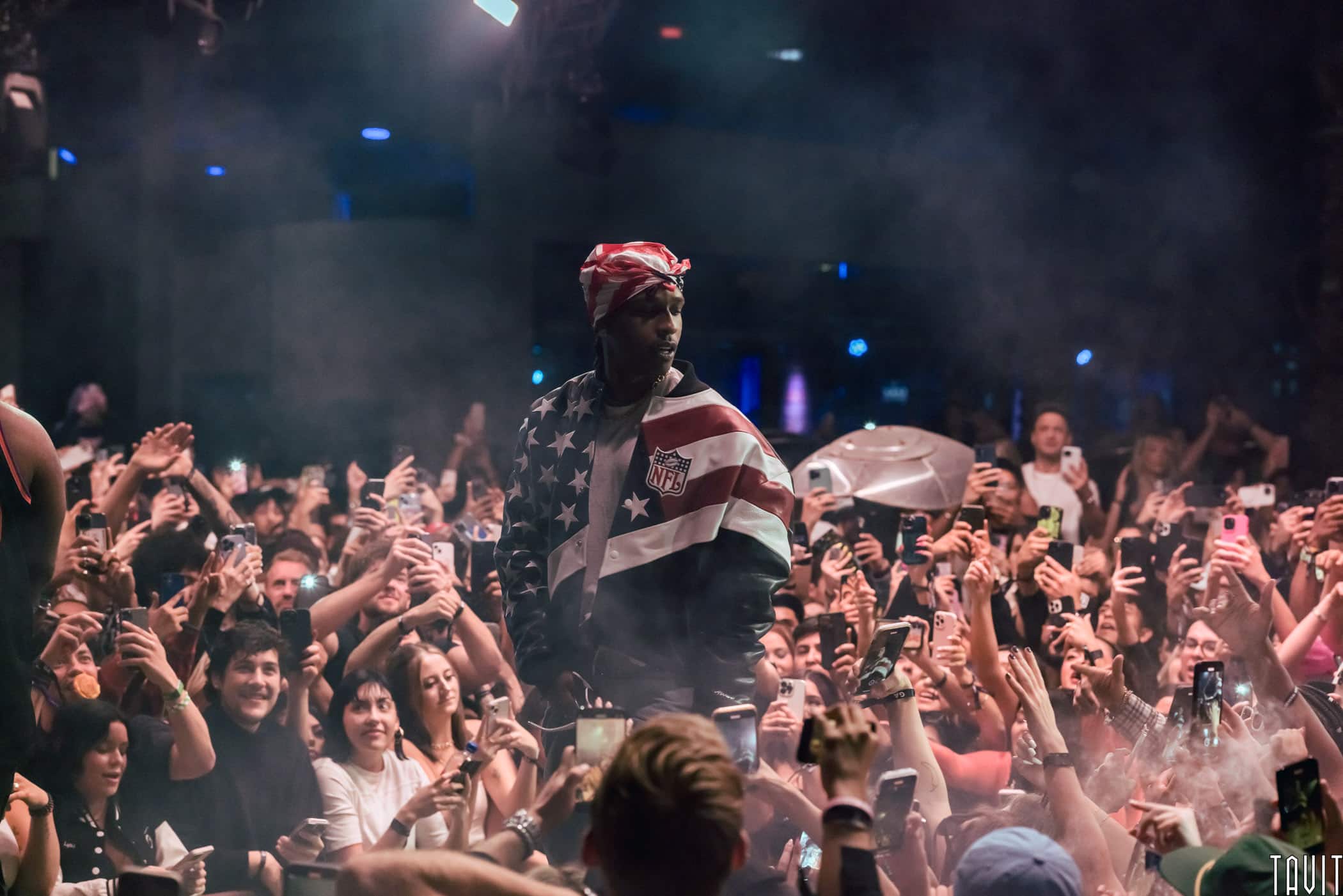 ASAP Rocky on stage in NFL American flag jacket