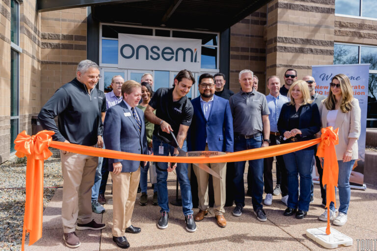 group of people doing a ribbon cutting in front of the onsemi building