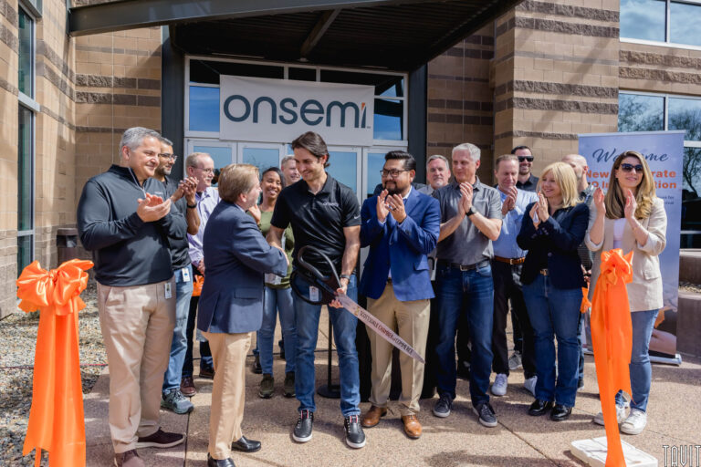 group of people doing a ribbon cutting in front of the onsemi building