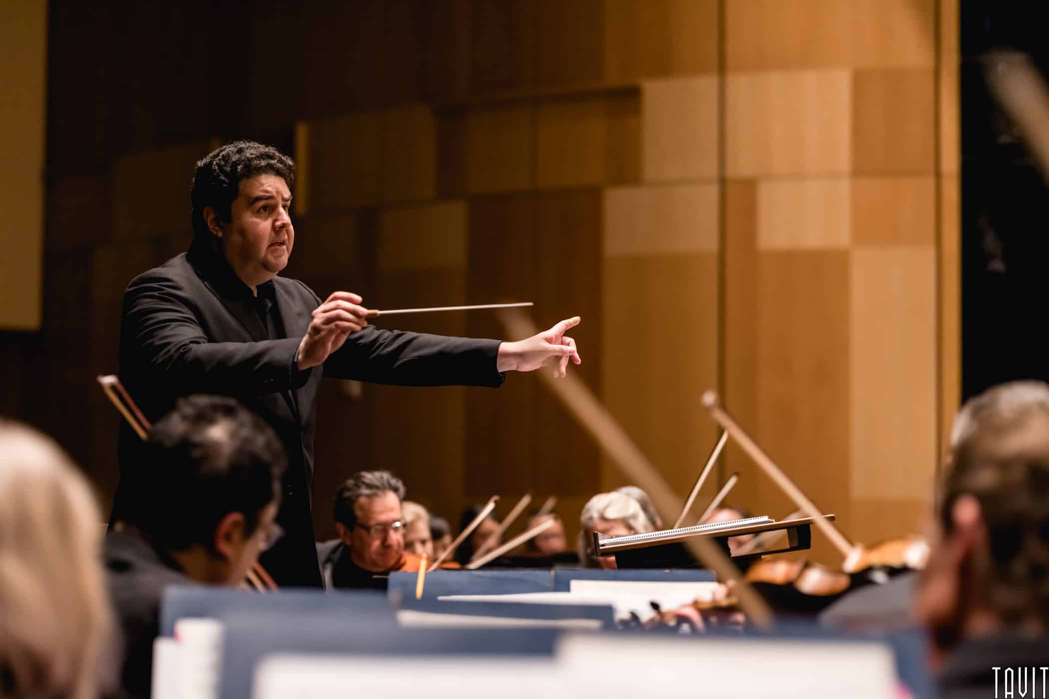 Side shot of a conductor of the Phoenix Symphony