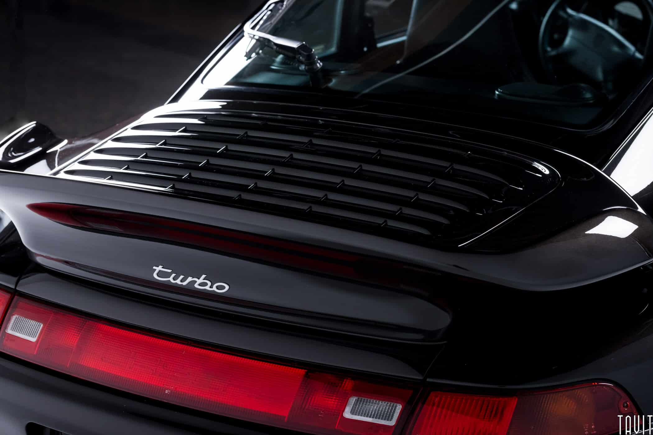 back angle shot of black porche tail with turbo