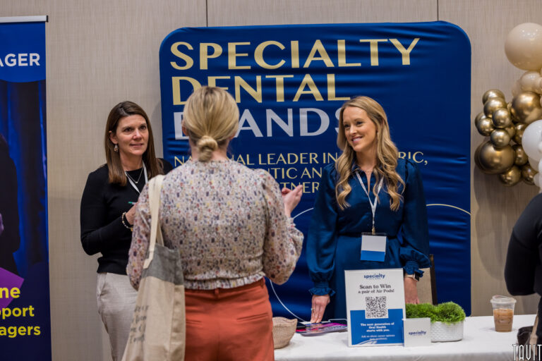 women at a booth at a conference