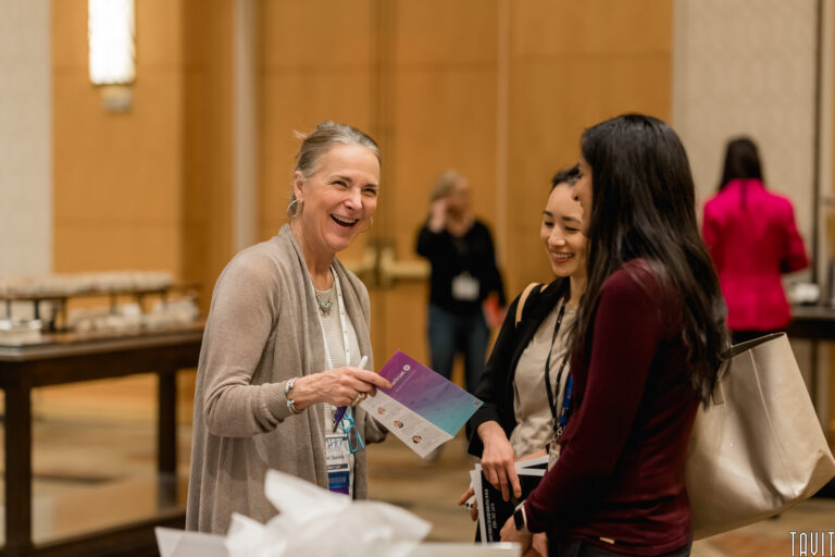 three women socializing at a conference