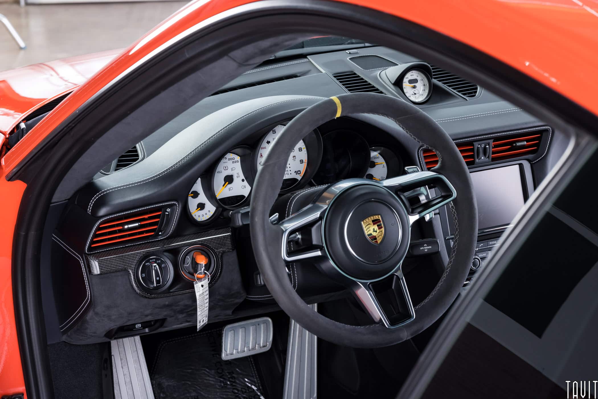 professional interior shot of red porche steering wheel