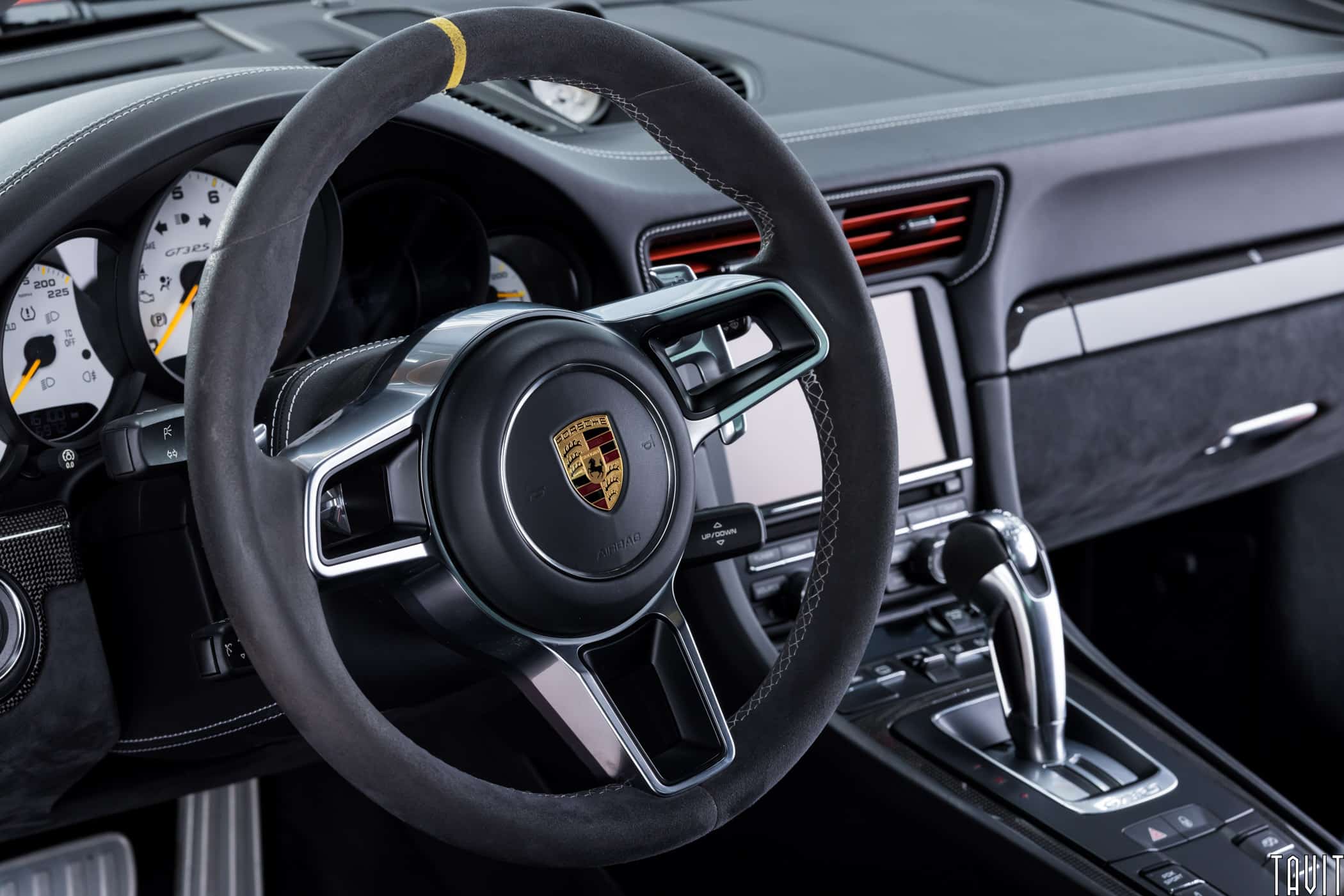 professional interior shot of porche steering wheel and gear shifter