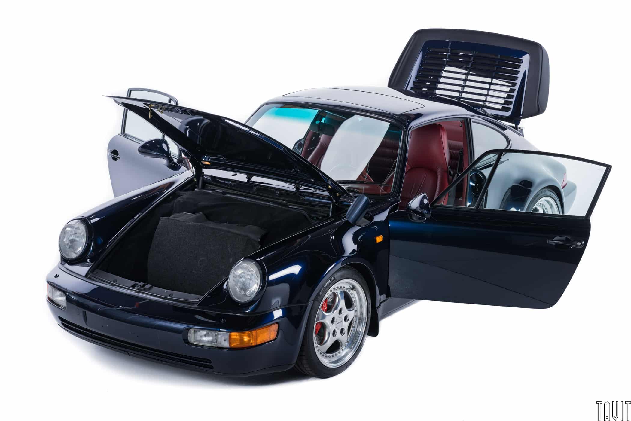 commercial shot of black porche with all doors and lids open