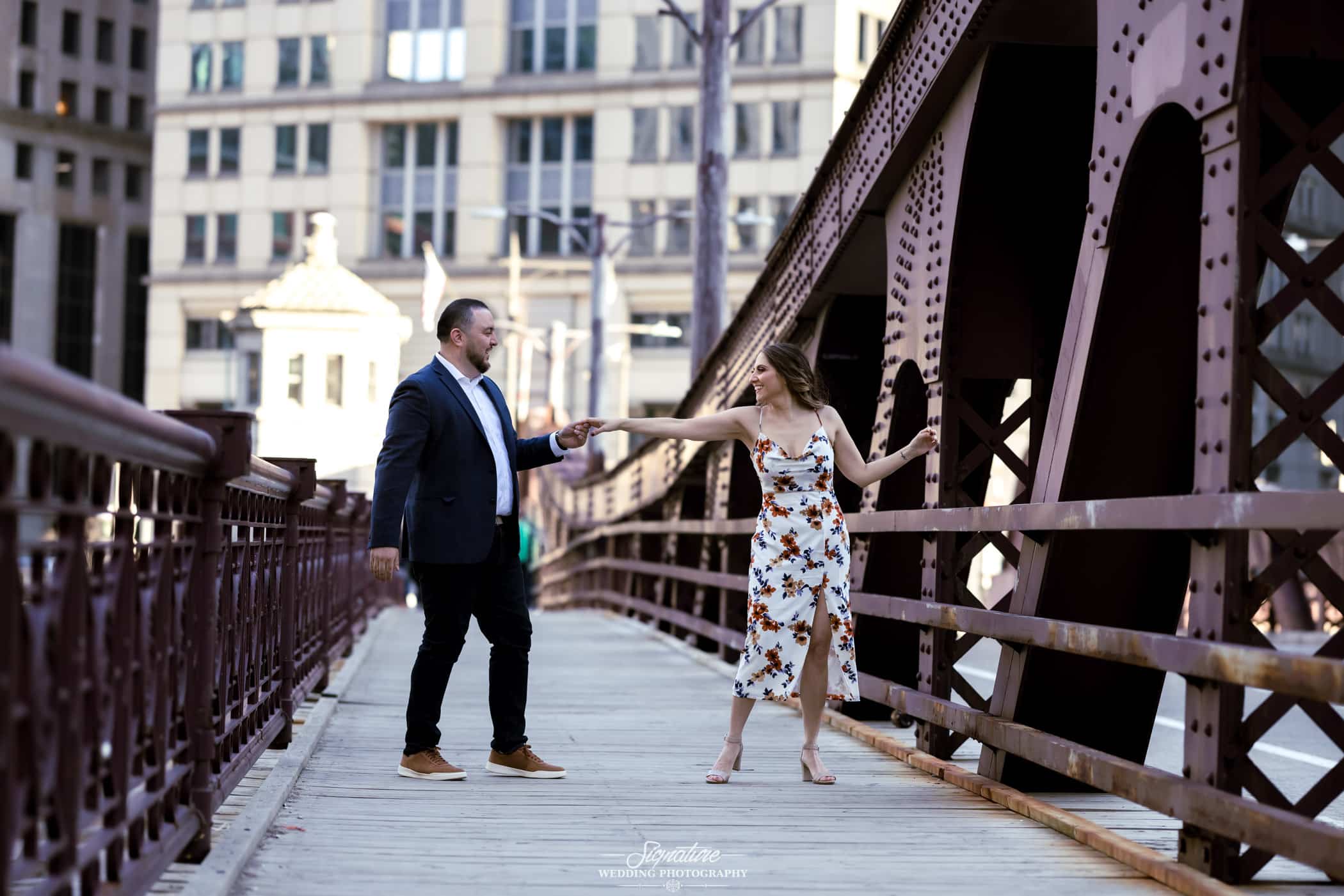 Couple in dance pose on bridge