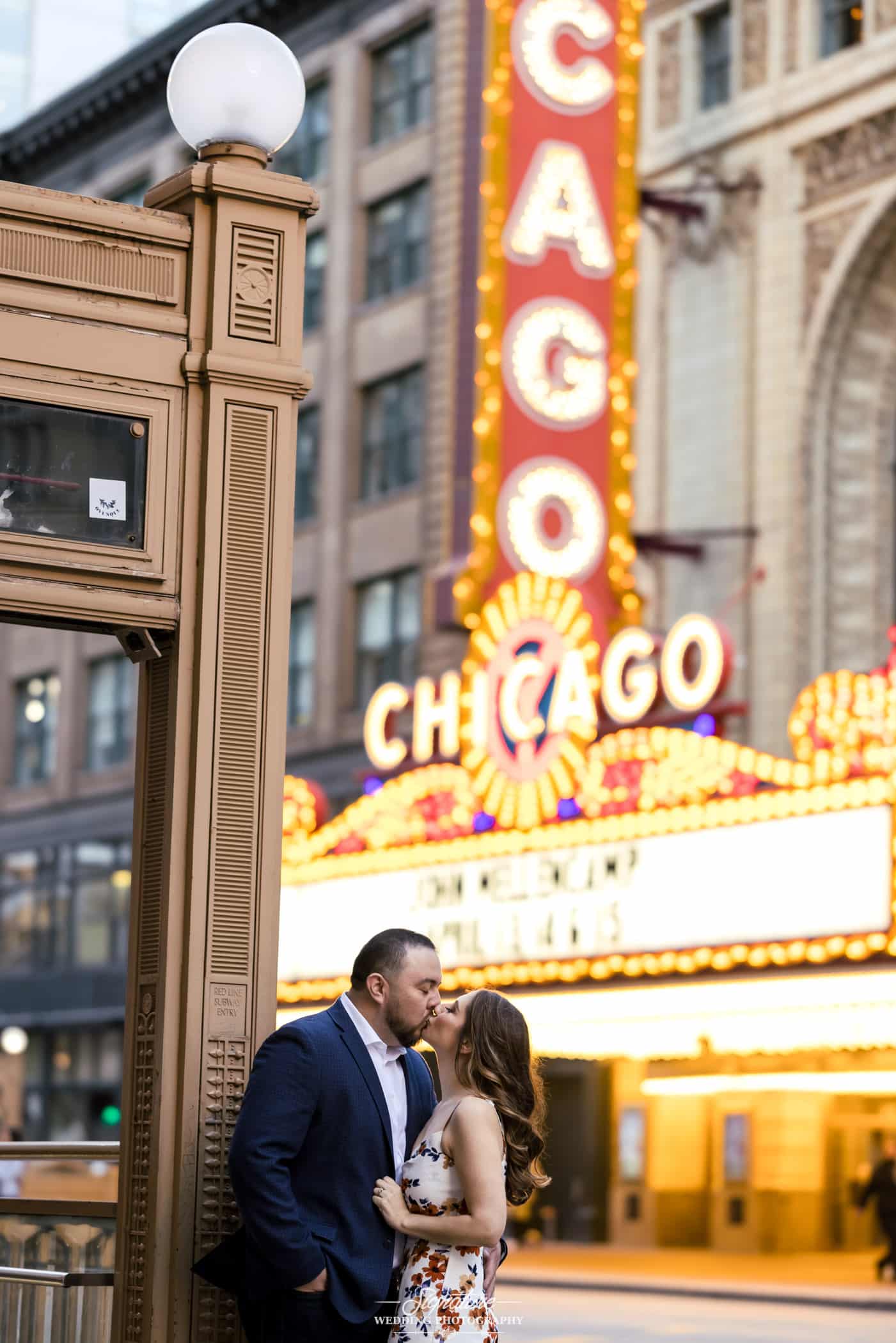 Couple kissing in front of Chicago theater