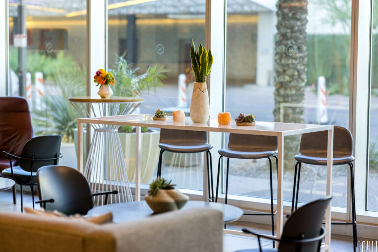 Table and chairs next to window wall