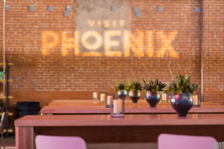 Banquette tables in front of brick wall