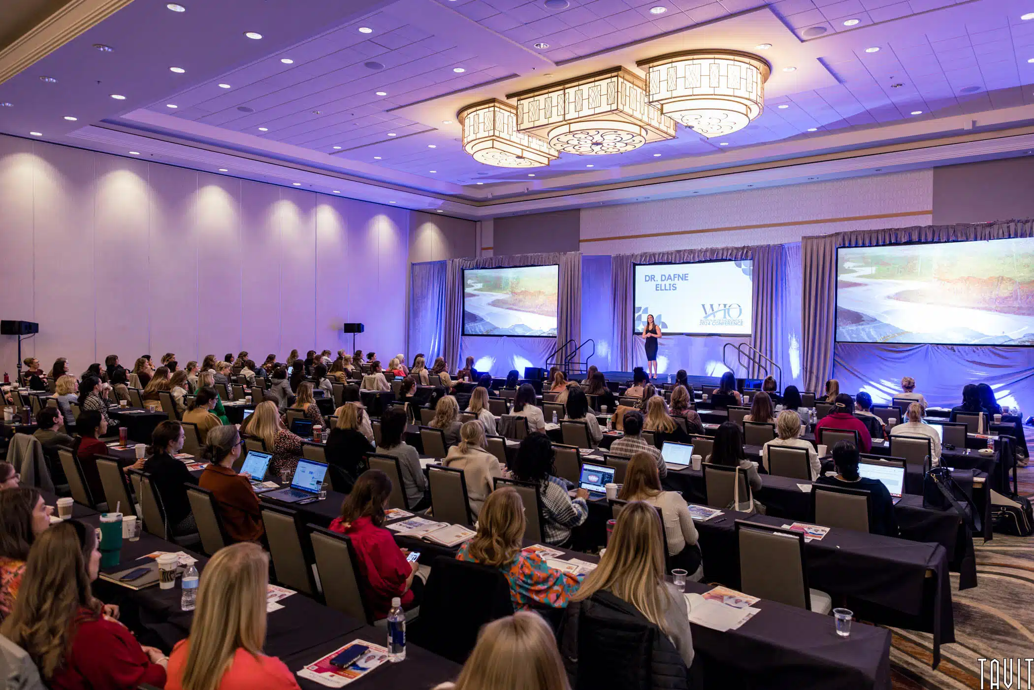 group of attendees at a corporate event inside a ballroom at an Arizona resort.