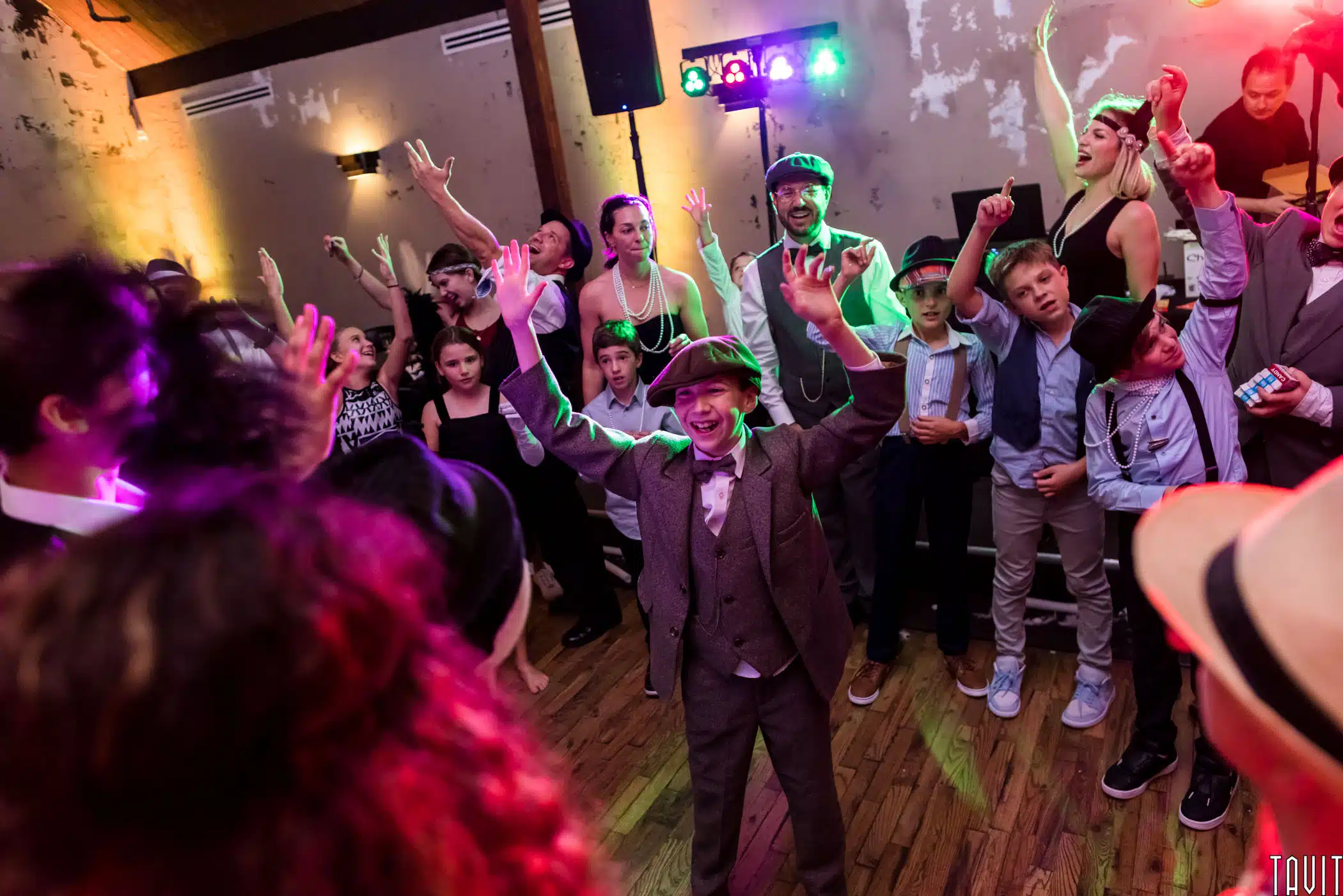 A young man with family and friends celebrating at his Bar Mitzvah